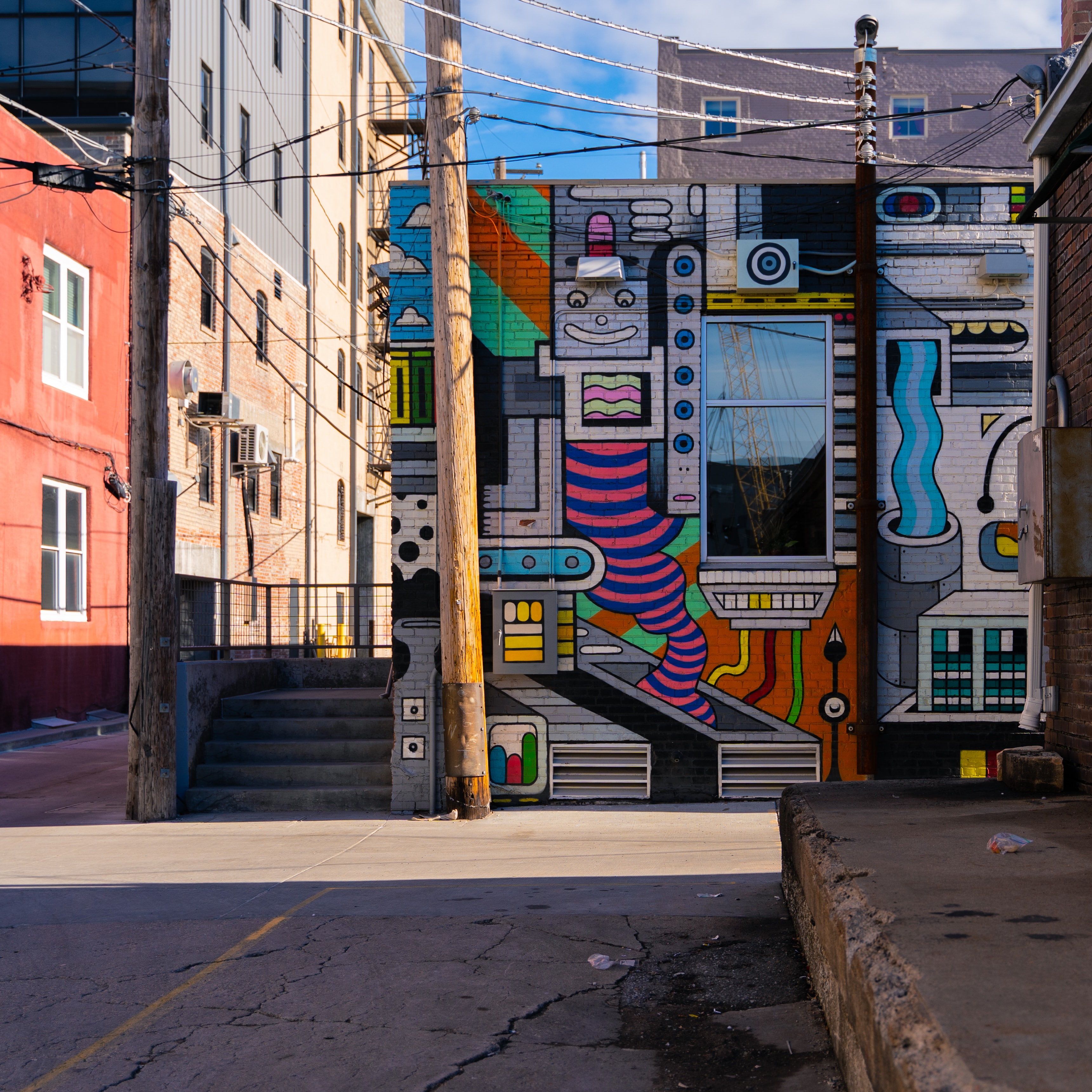 Bold colorful robot street mural on a brick building in a Haymarket alley in Lincoln NE