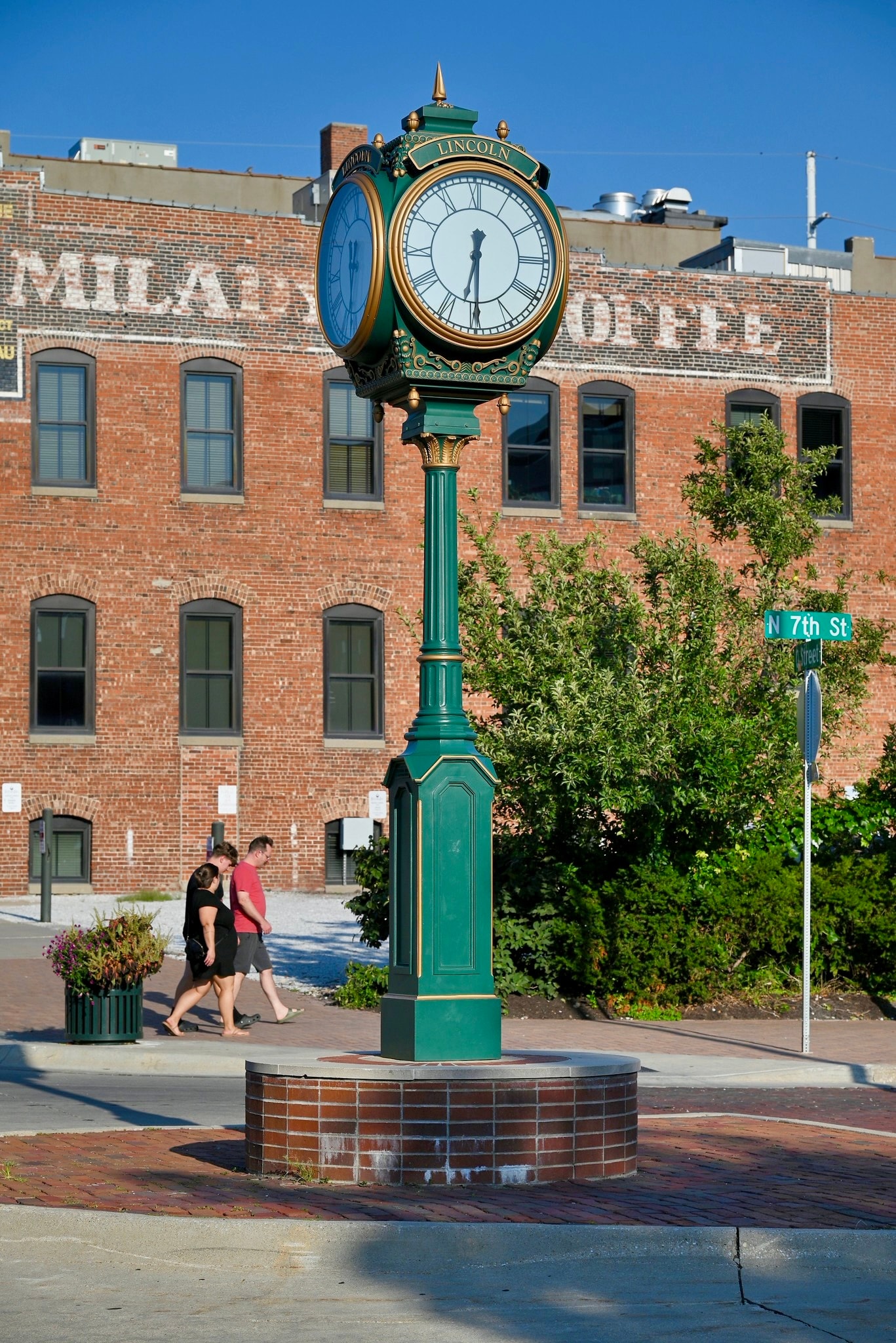 Historic Lincoln street clock with brick building backdrop in the Haymarket